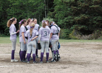 The team meets on the mound.
