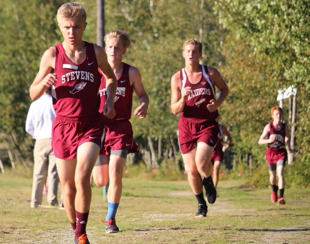 The boys cross country team races the home field. Photo by John Richardson