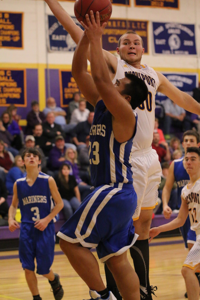 Krisford Melanio shoots for a layup against Bucksport. Photo by Sandra Shepard
