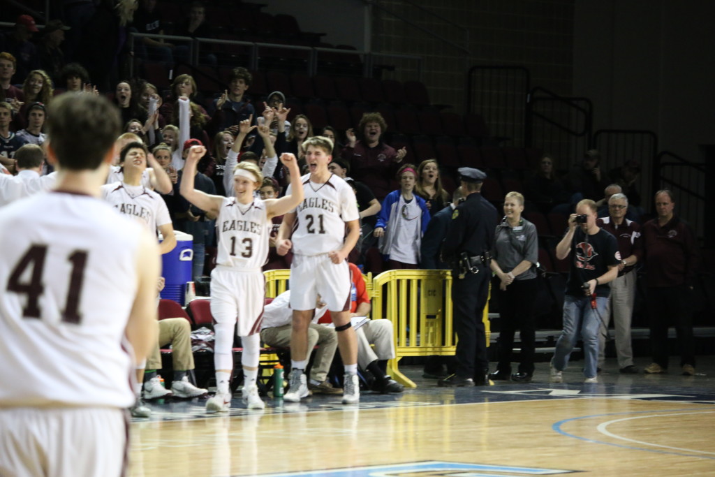 Junior Beckett Slayton and senior Nick Szwez celebrate the win with the home crowd behind them. Photo by Anne Berleant