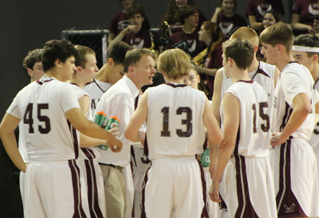 Coach Dwayne Carter works his team during a time out. Photo by Anne Berleant