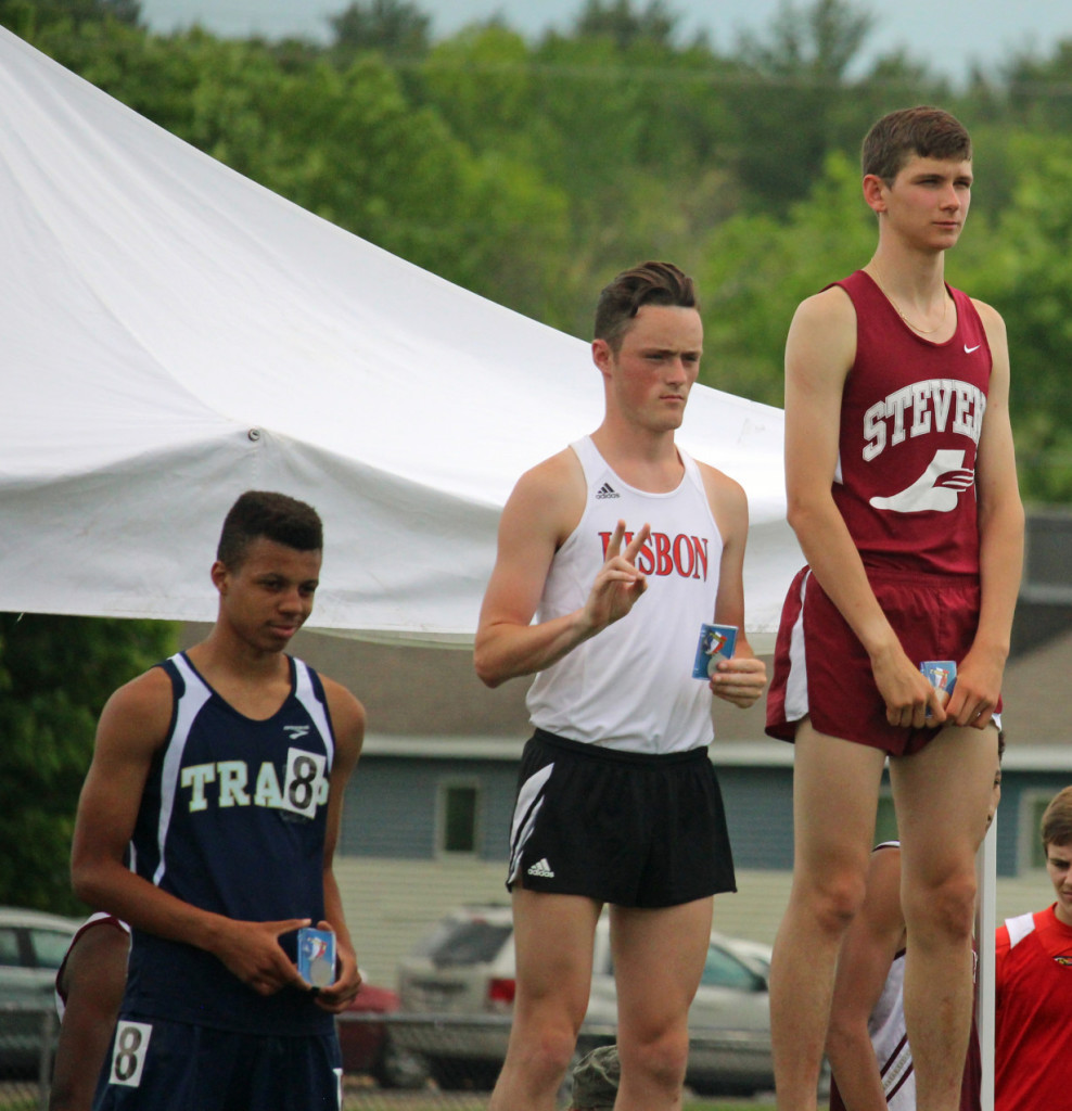 John Hassett, state champion in the 1600 meter run, on the winners podium. Photo by John Richardson