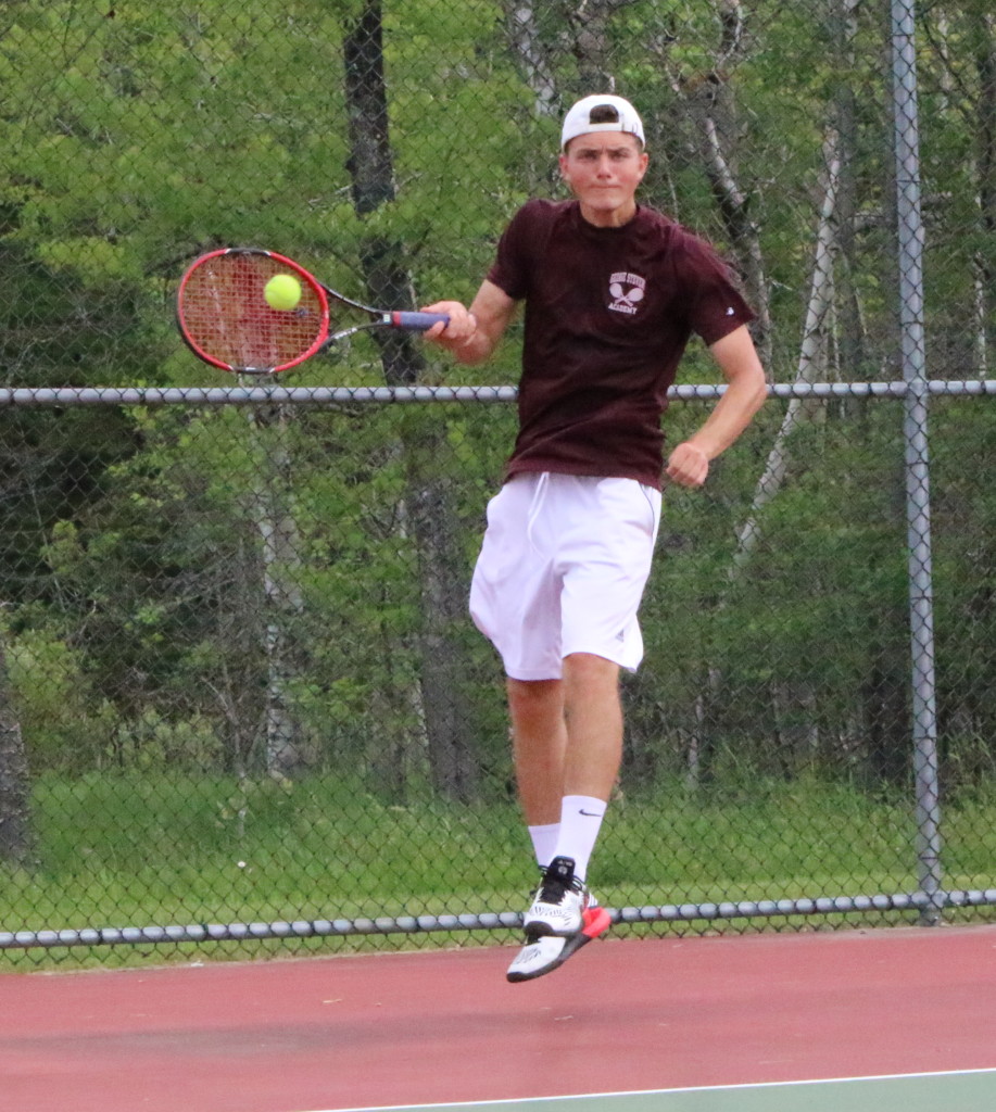 Beowulf Urban hits a return in the air from the backcourt. Photo by Monique Labbe