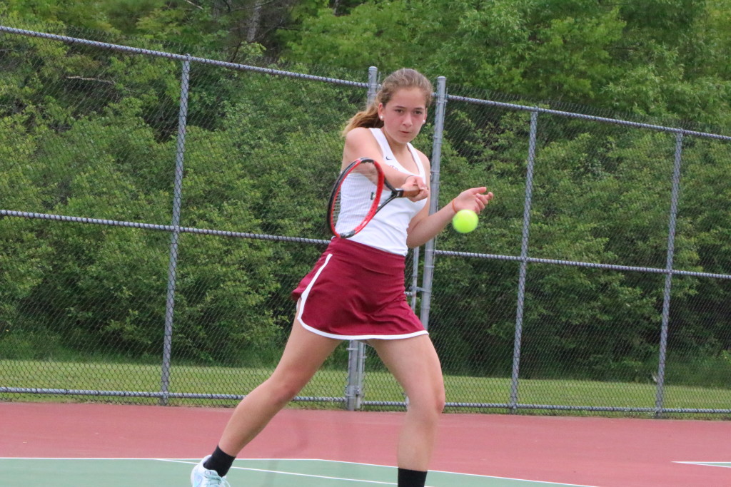 Lindsay Nevin drives a ball over the net for game point. Photo by Monique Labbe