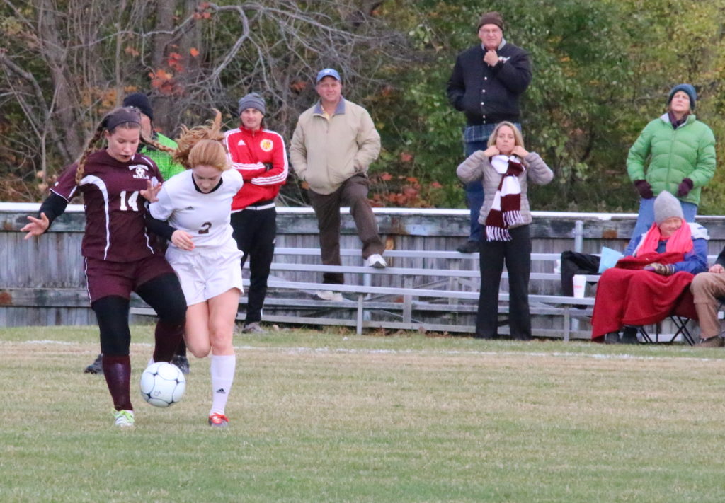 Yulia Heggestad gets physical to get the ball away from an Orono offender. Photo by Monique Labbe