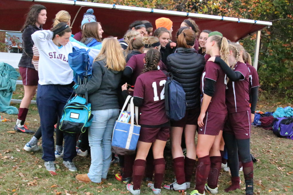 Seniors and underclassmen give one more cheer after the game. Photo by Monique Labbe