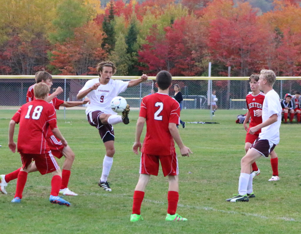 Walker Ellsworth looks for an opening through the Dexter defense. Photo by Anne Berleant