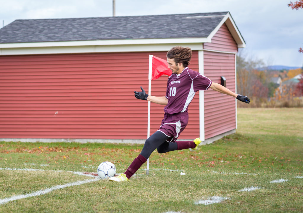 ohn Larson kicks from the corner. Photo by Tate Yoder