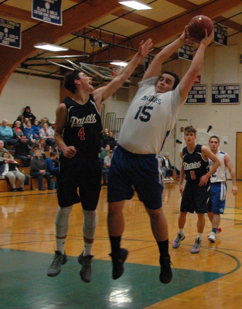 Ethan Shepard gets the rebound against Bangor Christian. Photo by Jack Scott
