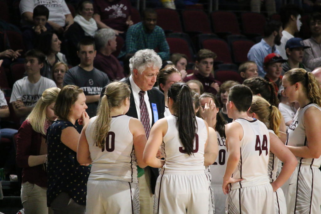 Coach Bill Case counsels his team. Photo by Anne Berleant