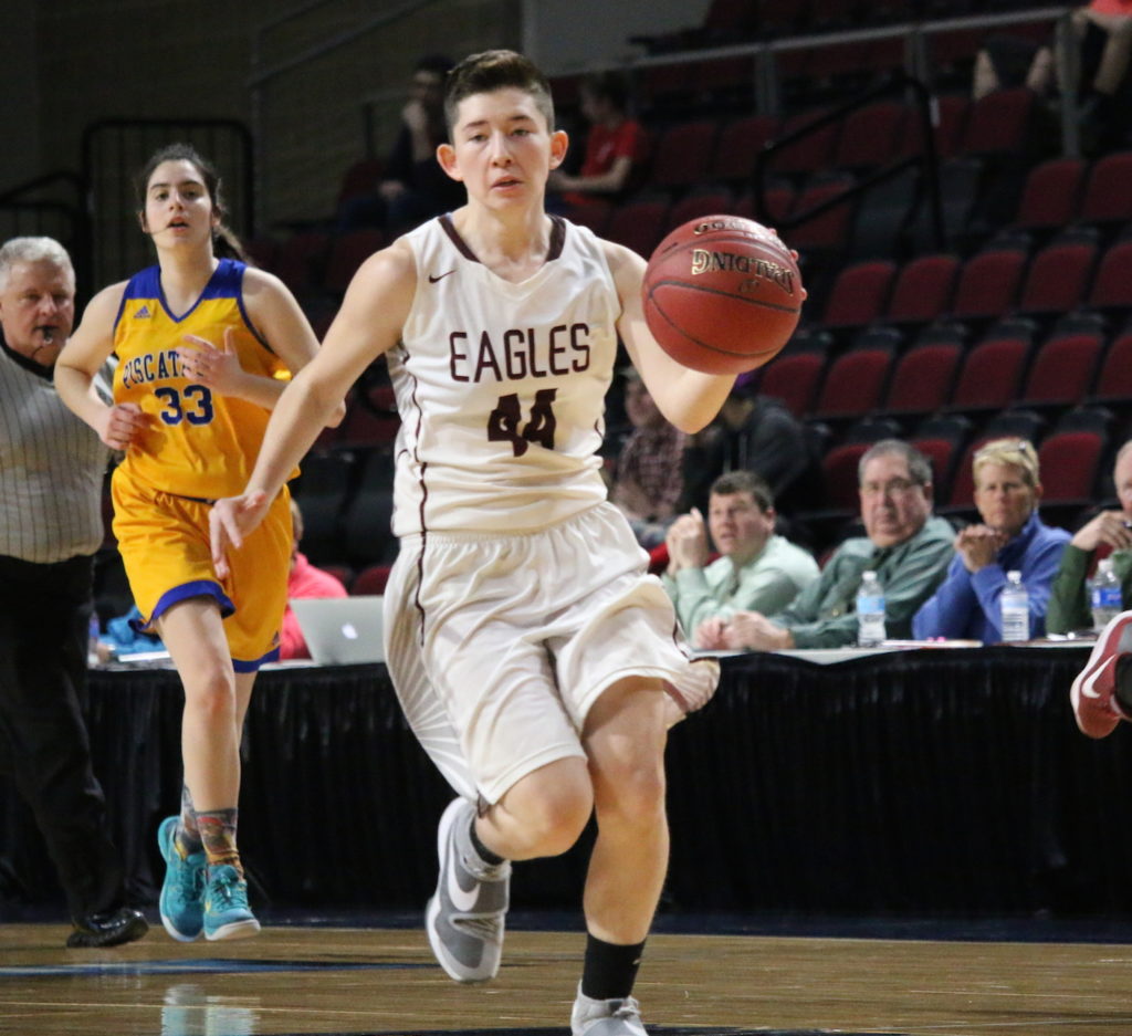 Dawn Hutchinson moves the ball down court. Photo by Anne Berleant