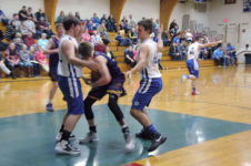 Toby Snow and Mason Oliver close in on defense. Photo by Jack Scott