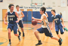 Daktoa Gillen heads drives in for a layup against Sumner. Photo by Jack Scott